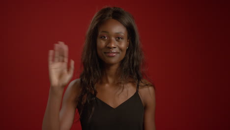 Woman-Smiles-and-Waves-at-Camera