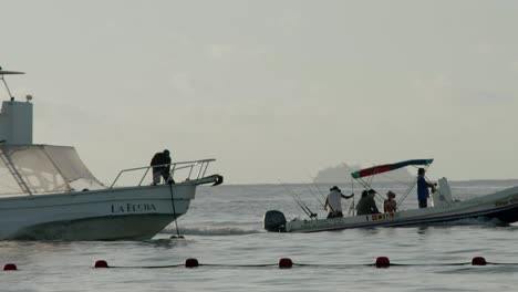 boats at dawn in the calm waters next to cancun, mexico, wide shot