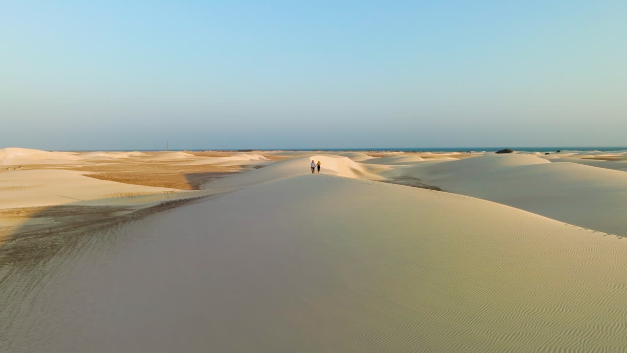 Aerial View Of Couple Kissing And Hugging On The Sand Dunes At Sunset In Socotra Island, Yemen. - pullback shot