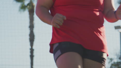 close up of female soccer team warming up during training before match against flaring sun