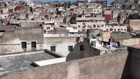 overlooking the rooftops of fes medina with satellite dishes and drying laundry