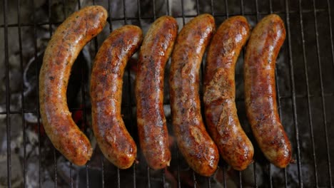 delicious juicy sausages, cooked on the grill with a fire.