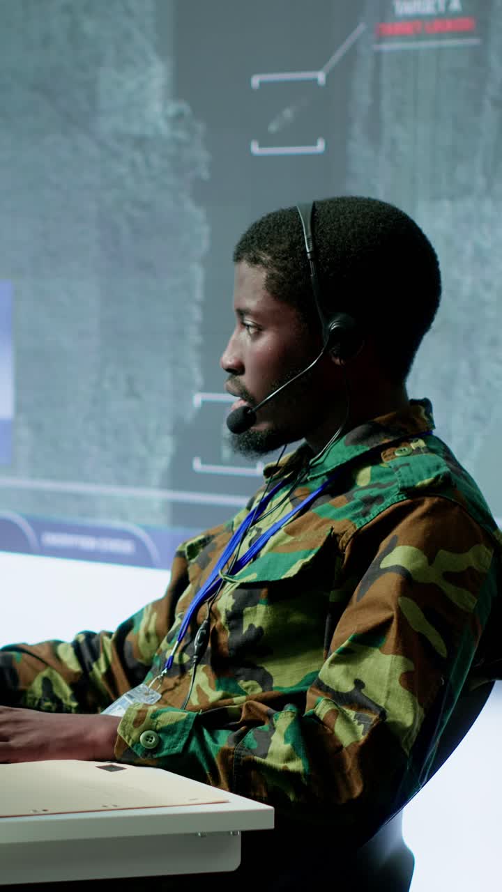 Vertical Video Team of military specialists in command post monitoring satellite data