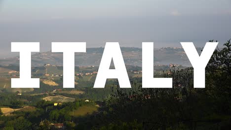 aerial drone shot of villages and mountains in italy with animated graphic spelling out italy