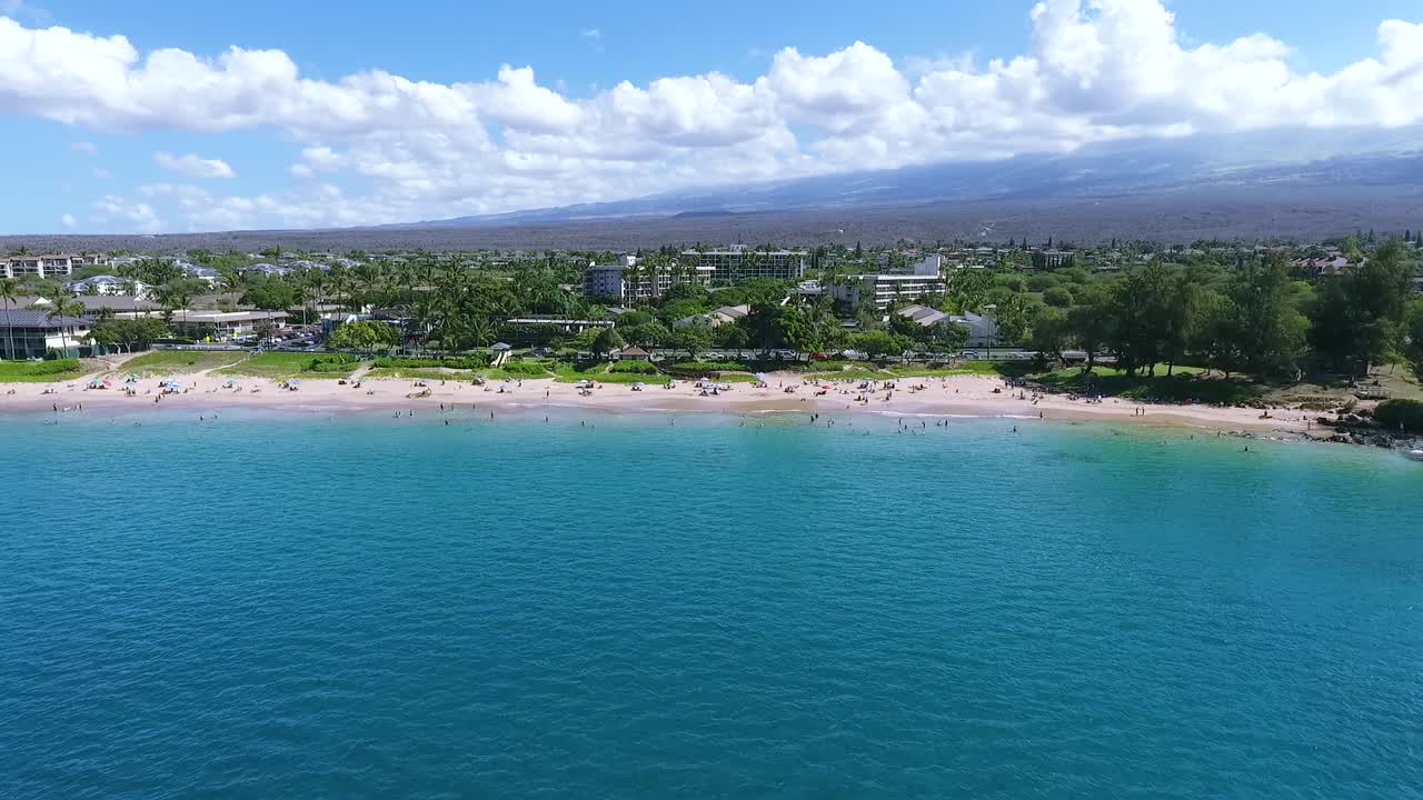 Bright seascape panorama with blue turquoise sea washing long exotic beach in front of luxurious resorts in Hawaii