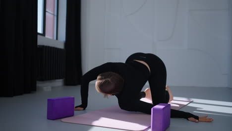 woman practicing yoga in a studio