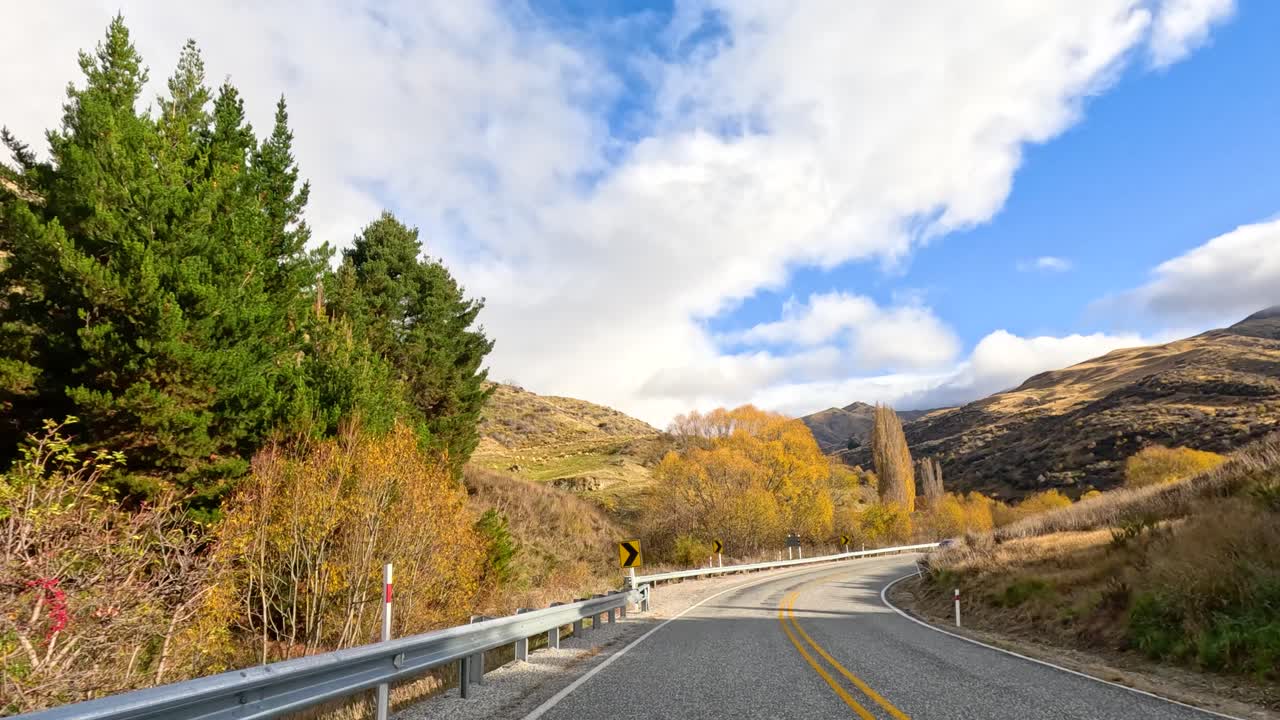 A 40-second drive through Wanaka's picturesque autumn scenery, featuring winding roads, vibrant foliage, and expansive skies