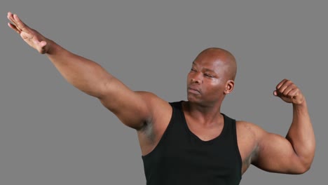 muscular man gesturing in front of camera