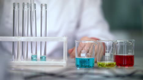 Scientist-working-with-liquid-in-laboratory-glassware.-Test-tubes-filling-liquid