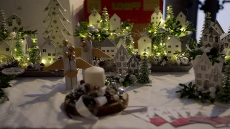 christmas decoration of a small landscape with houses, trees, candles and angels decorating homes in winter for advent