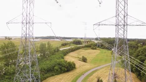 raising aerial station shot between large power stations in a suburban environment