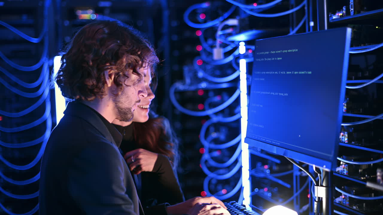 A man and a woman cheering in a server room