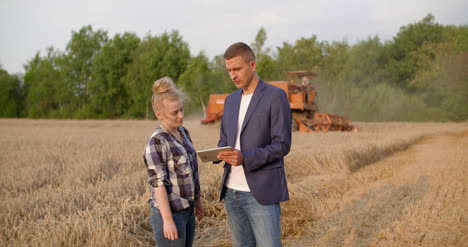 young farmers discussing at wheat field 23