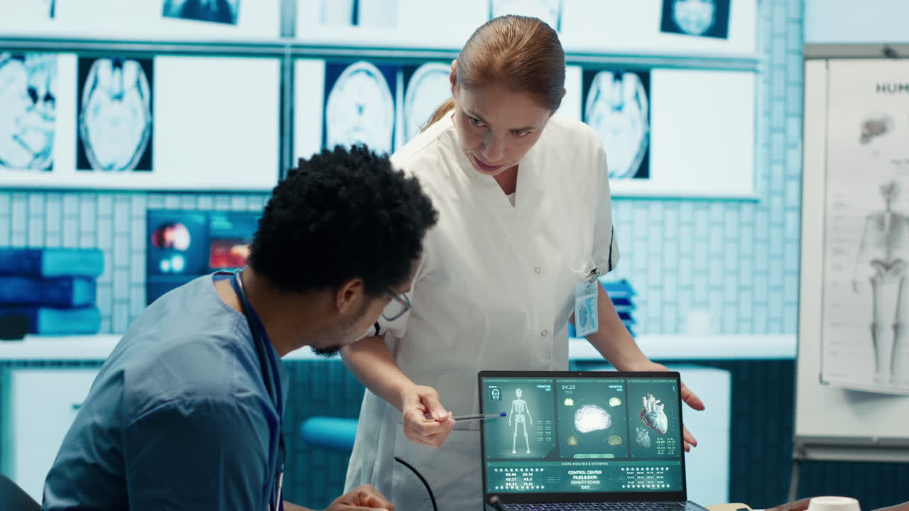 Medical Professionals Discussing Medical Scan on Laptop