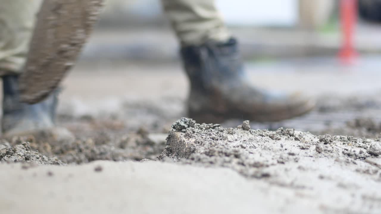 Worker pouring concrete