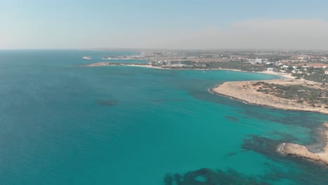 clear blue sea water at nissi beach - aerial view