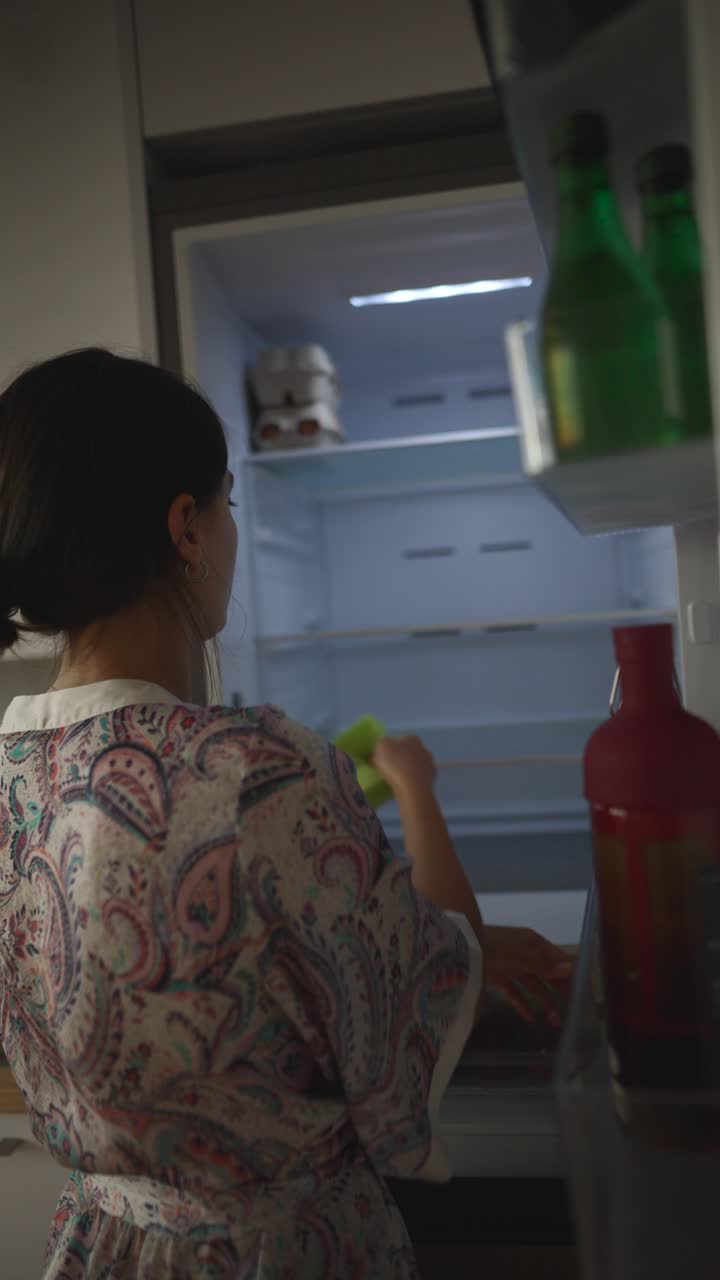 Woman Opening Refrigerator at Night