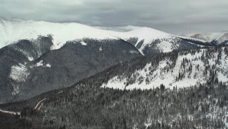 panoramic view of snowy forest on a steep mountainside in winter park, colorado rockies