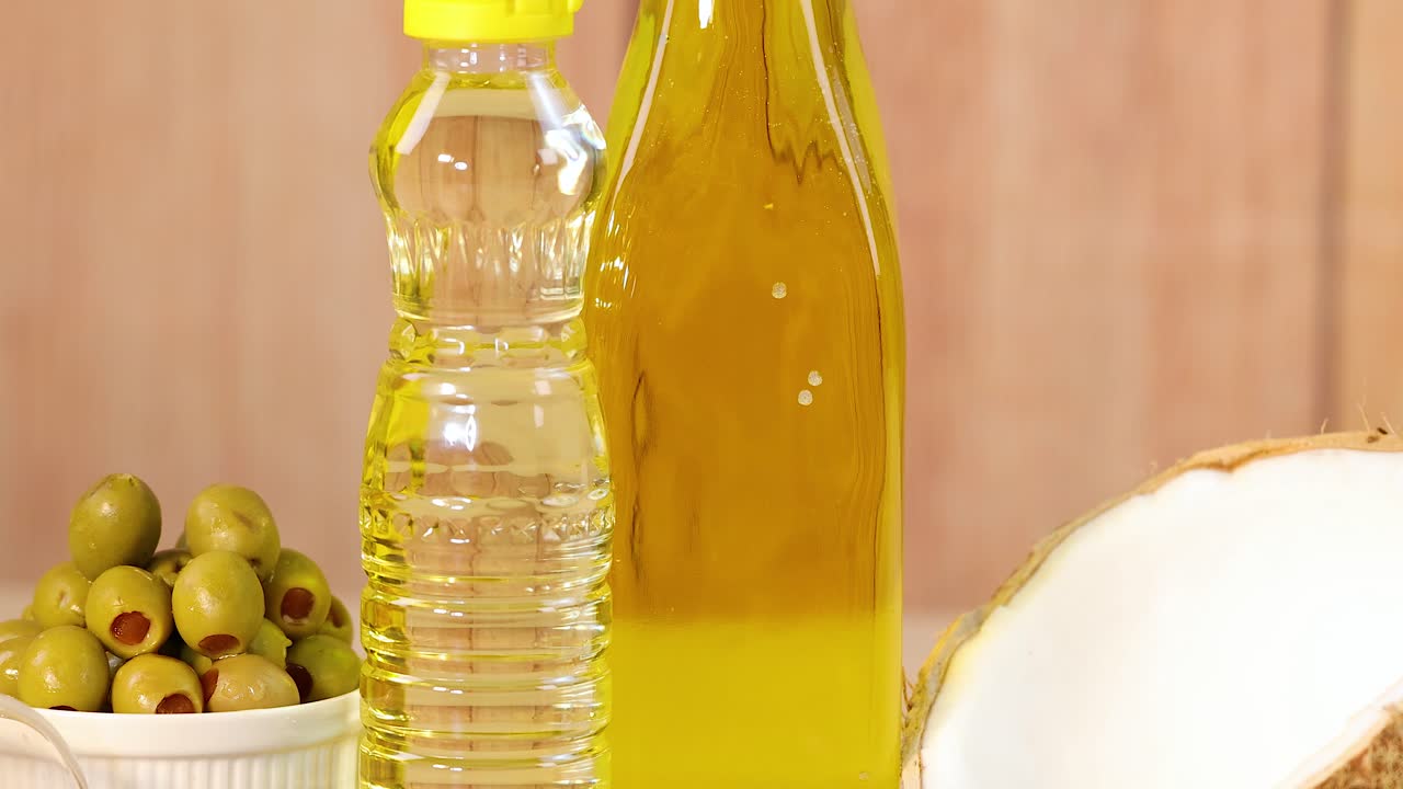 Various oils and ingredients arranged on a wooden table with warm lighting, highlighting natural textures and colors