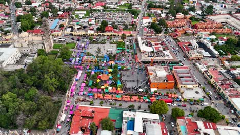 static drone shot at 120 meters, capturing the perspective of the main square of the magical town of tepotzotlán, mexico, on the eve of the commemorative celebrations of mexico's independence day