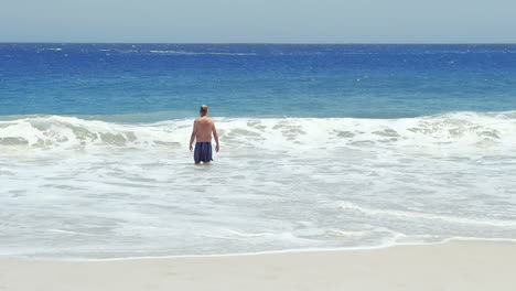 senior man standing in the sea