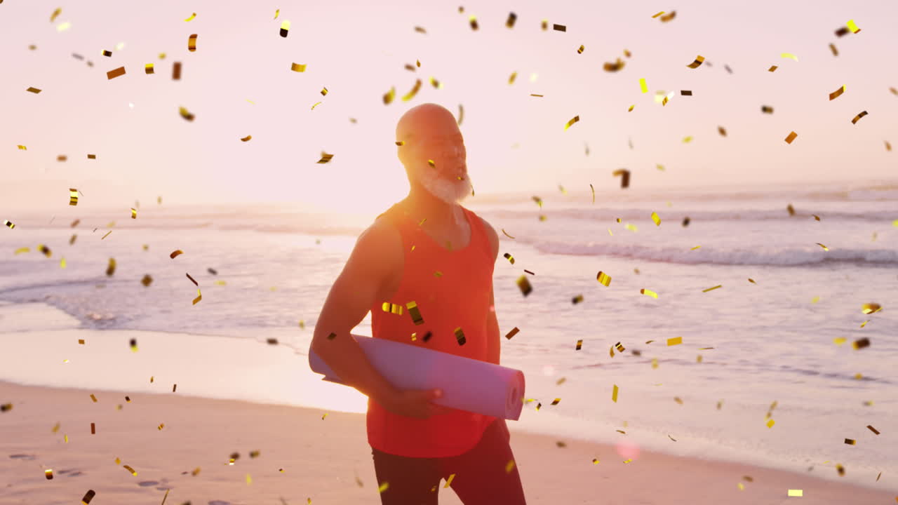 animación de confeti sobre un anciano afroamericano con una alfombra de yoga en la playa al atardecer.