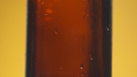 Close-Up-Of-Condensation-Droplets-Running-Down-Side-Of-Revolving-Bottle-Of-Cold-Beer-Or-Soft-Drink-With-Copy-Space-1