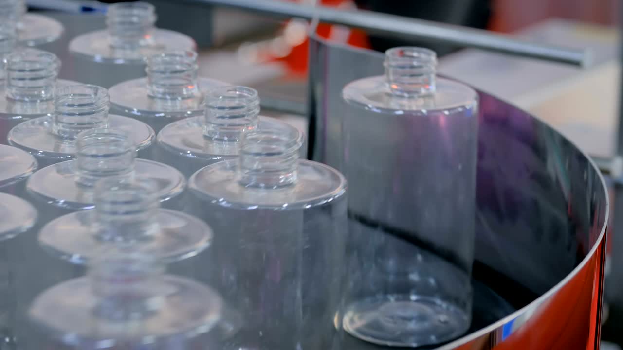 Automated pharma technology concept - rotating platform with empty glass bottles
