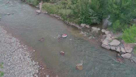 drone view of someonein a tube going down a glacier river in colorado springs