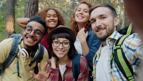 happy friends taking selfie in a forest