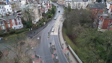 Aerial-forward-shot-of-Scarborough-bay-during-daytime-of-winter-season-with-beautiful-houses-and-greenery-all-over-the-city-in-England