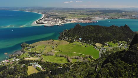 marsden point oil refinery and northport aerial pull back shot over whangarei heads mountain