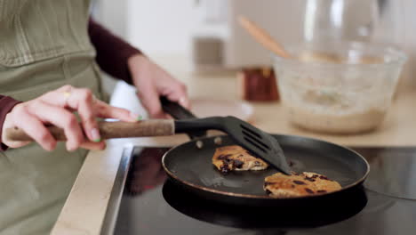 Cooking,-closeup-and-woman-frying-pancakes