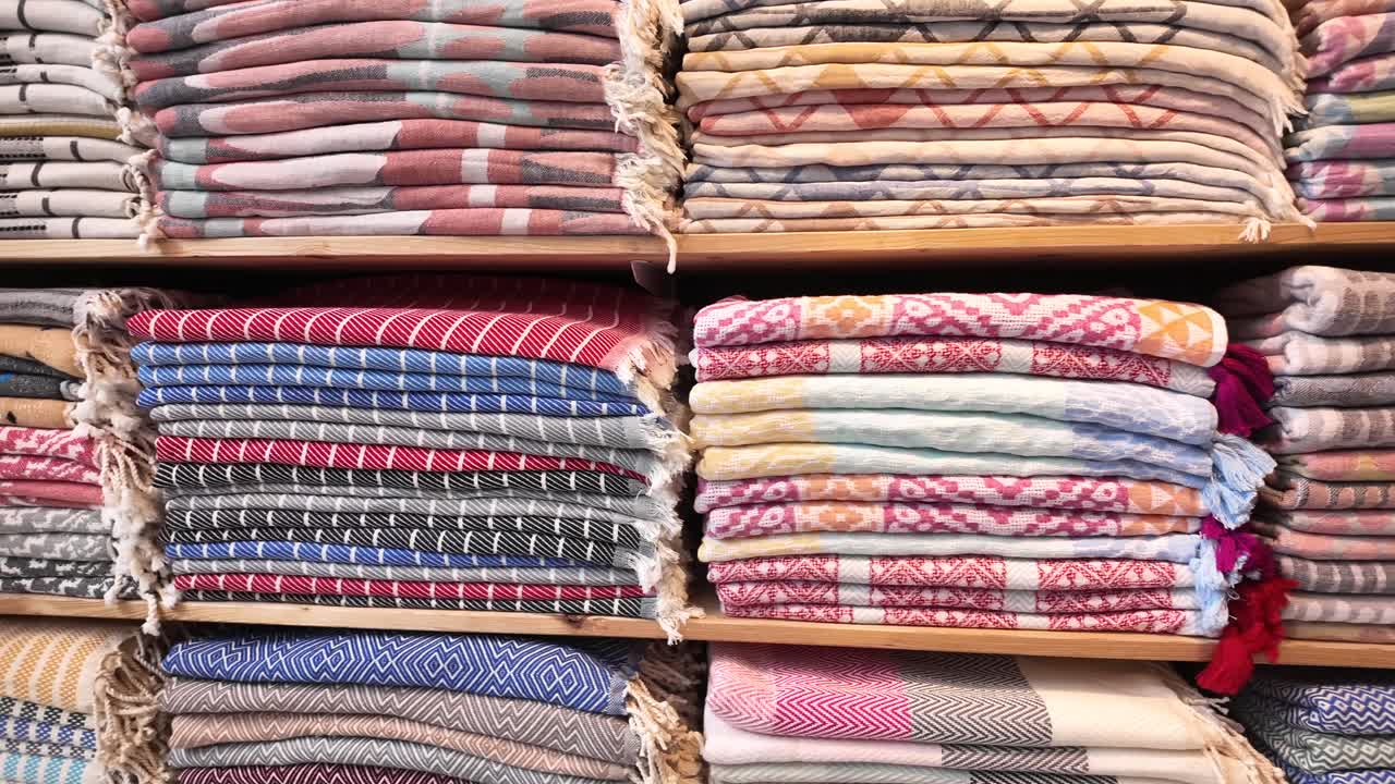 Stacks of Folded Towels on Shelves