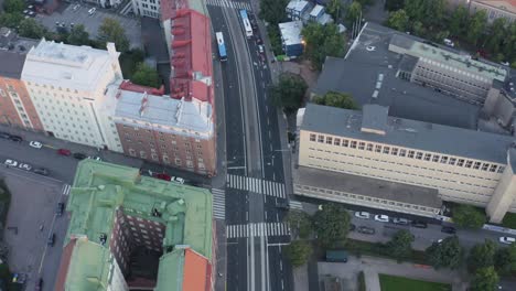 aerial of helsinki quiet street from above with buses and cars