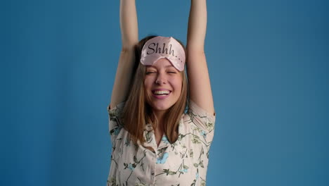 woman with sleep mask stretching