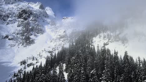 Aerial-ascending-shot-of-low-lying-fog-over-the-beautiful-Snoqualmie-Pass