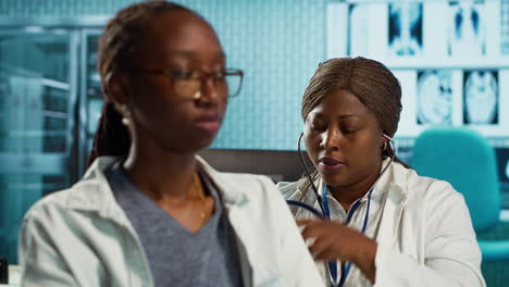 general practitioner uses a stethoscope to consult patient with illness