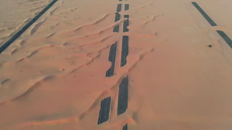 4k drone footage, a road between desert, dubai’s half desert road, geological landscape of high dune desert in the united arab emirates, drone videos