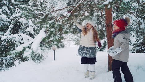 happy children playing in the winter park. christmas holidays. slow motion.