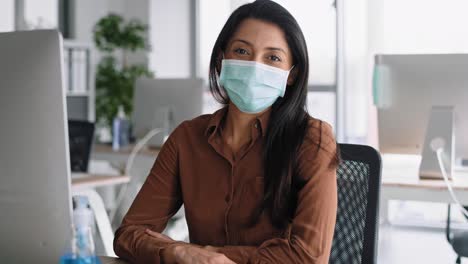 Video-portrait-of-woman-in-protective-mask-in-the-office