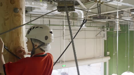 child climbing an indoor rope course