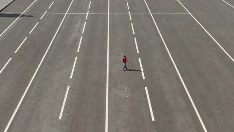 aerial view, roller skating slalom, criss cross. girl is rollerblading in the open area. 4k, 10bit, prores