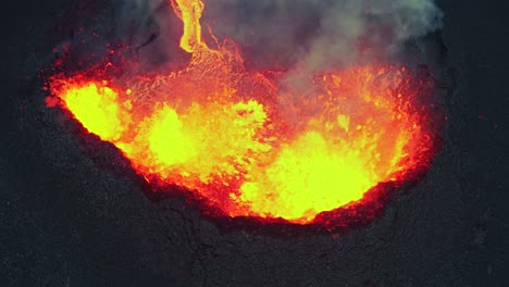 icelandic volcanic eruption, closeup of active vent spitting lava - 4k aerial