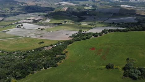 Aerial-pans-across-rolling-hills,-arid-Spanish-agricultural-landscape