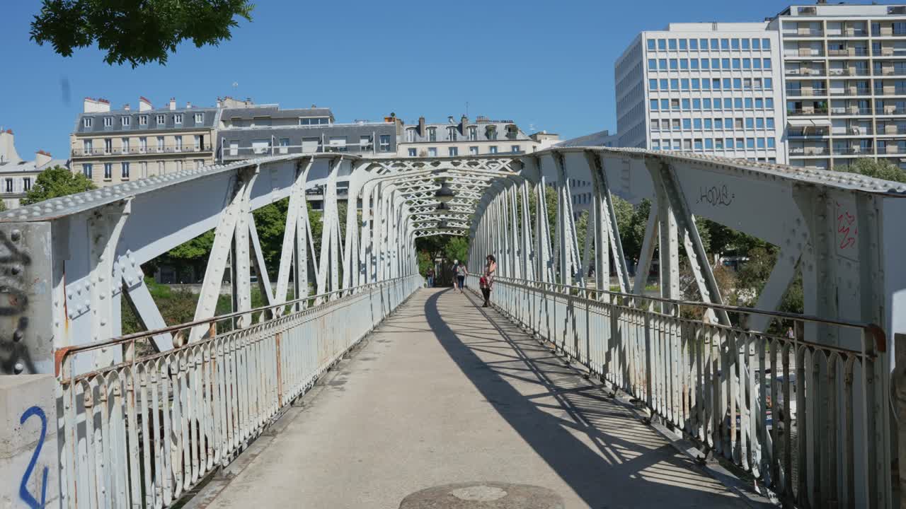 Walking through bridge on Port de l'Arsenal Garden near Place de la Bastille Paris France