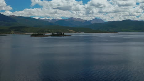 aerial cinematic drone high altitude grand lake shadow mountain grandby colorado rocky mountain national park entrance calm clear beautiful summer morning boating two islands forward upward