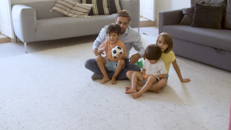 kid throwing ball to dad at home