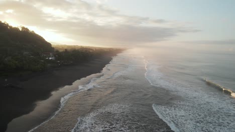 costa rica beach sunrise black sand palm trees huts