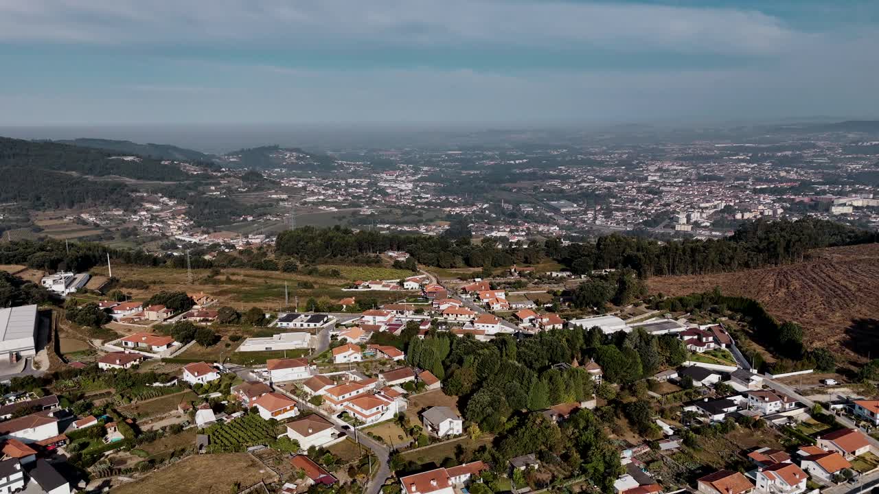 Aerial - houses, fields, and distant hills spread across Roriz, Santo Tirso, Portugal